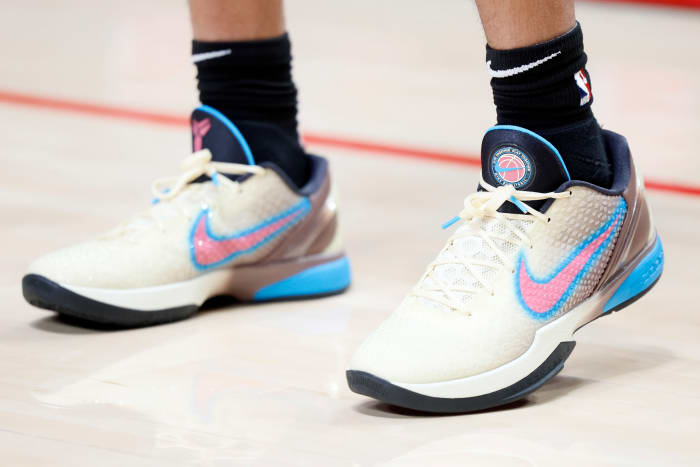 View of pink, blue, and black Nike Kobe shoes.
